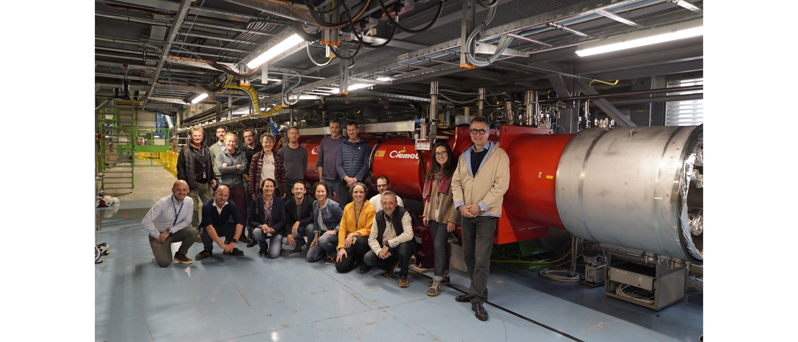 people smiling gathering in front of a red magnet