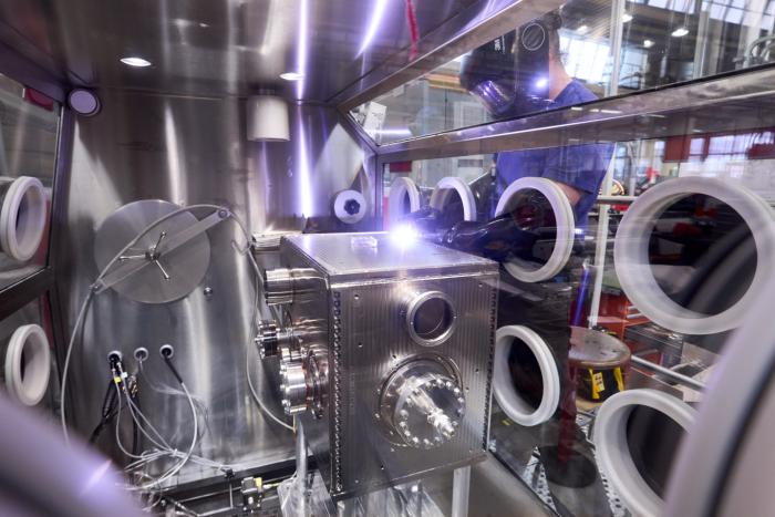 A DQW Crab Cavity being TIG-welded inside a glovebox at CERN’s EN-MME Main Workshop (Image: Maximilien Brice)