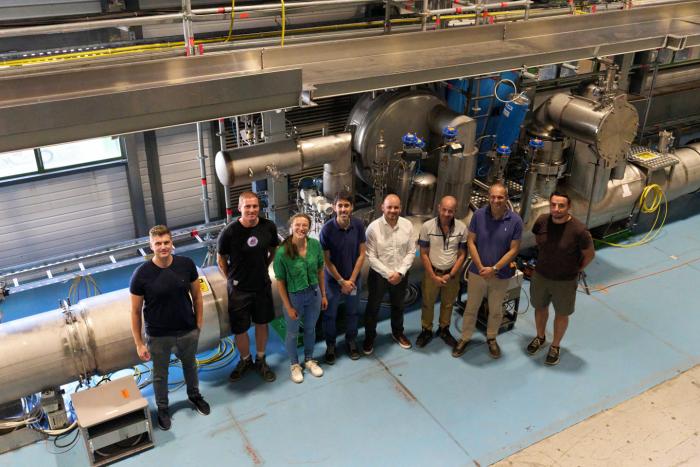 team standing in front of equipment