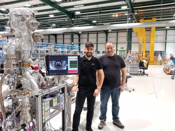 two men in front of equipment