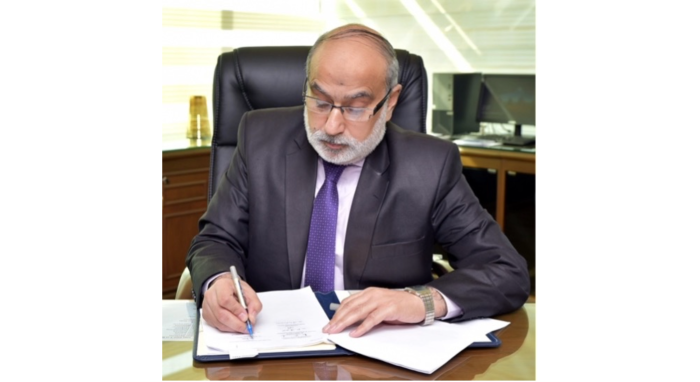 man signing a document